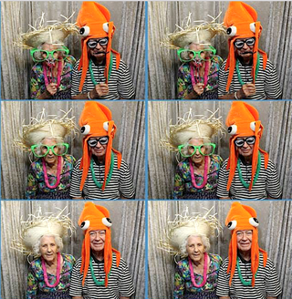 Tallgrass Creek residents enjoy the photo booth at the community's recent luau. Tallgrass Creek residents enjoy the photo booth at the community's recent luau.
