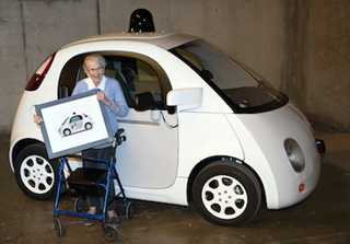 Florence Swanson poses with a framed version of her design in front of a Google car. Florence Swanson poses with a framed version of her design in front of a Google car.