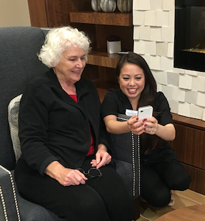 Wellness Director Natalie Nguyen reviews daily tasks with resident Pat Ham and shows her Notify. Wellness Director Natalie Nguyen reviews daily tasks with resident Pat Ham and shows her Notify.