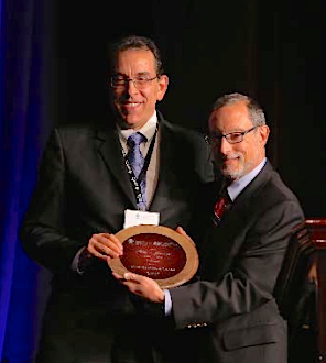Paul Katz, M.D., C.M.D., right, presents David LeVine, M.D., C.M.D., with his honor. Paul Katz, M.D., C.M.D., right, presents David LeVine, M.D., C.M.D., with his honor.