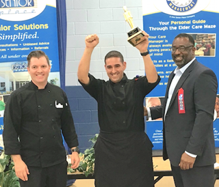Manny Navarro hoists his trophy after winning the chef's competition. Manny Navarro hoists his trophy after winning the chef's competition.