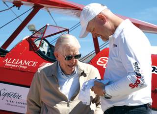 Pilot Darryl Fisher signs a commemorative hat for "Dream Flight" recipient Charles Sengstock. Sengstock is a U.S. Army veteran. Pilot Darryl Fisher signs a commemorative hat for "Dream Flight" recipient Charles Sengstock. Sengstock is a U.S. Army veteran.