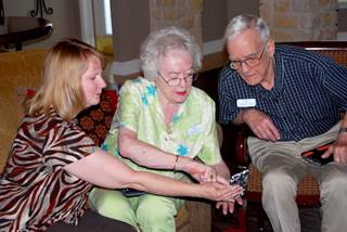 Debra Klinger, left, director of residential services at Christus St. Joseph Village, teaches residents Kay and Ray Denkhoff how to catch a Pokemon. Debra Klinger, left, director of residential services at Christus St. Joseph Village, teaches residents Kay and Ray Denkhoff how to catch a Pokemon.