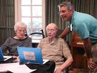 Watermark Director of IT Jack Herklotz, right, assists two Engage! students. Watermark Director of IT Jack Herklotz, right, assists two Engage! students.