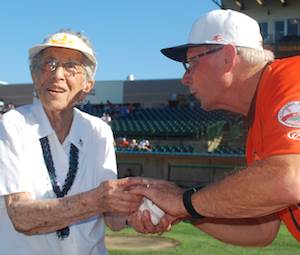 Helen Stemple strategizes with Bud Harrelson before she throws the ceremonial pitch to him. Helen Stemple strategizes with Bud Harrelson before she throws the ceremonial pitch to him.