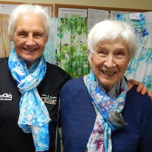 Residence at Otter Creek residents model the silk scarves they made. Residence at Otter Creek residents model the silk scarves they made.