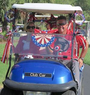 Vi at Bentley Village Executive Director Penny Smith and Head Golf Pro Stan Geer lead a procession of golf carts and bicycles in a July 4 parade. Vi at Bentley Village Executive Director Penny Smith and Head Golf Pro Stan Geer lead a procession of golf carts and bicycles in a July 4 parade.