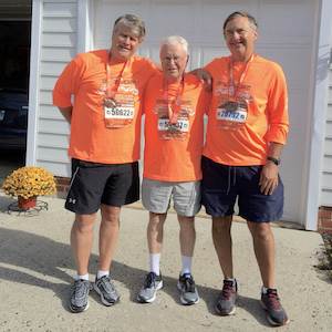 Oak Crest resident Bob Gralley, 91, is flanked by his sons, Kevin, left, and Craig after running 13.1 miles Oct. 21 in the Baltimore Running Festival. Oak Crest resident Bob Gralley, 91, is flanked by his sons, Kevin, left, and Craig after running 13.1 miles Oct. 21 in the Baltimore Running Festival.