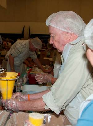 Devonshire resident Bob Frasier packs bags of food for children who live in Puerto Rico and Haiti. Devonshire resident Bob Frasier packs bags of food for children who live in Puerto Rico and Haiti.