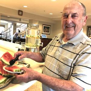 Larry Pallant, a resident at Spring Hills Mt. Vernon, Mount Vernon, VA, stays hydrated with watermelon. A water dispenser is behind him. Larry Pallant, a resident at Spring Hills Mt. Vernon, Mount Vernon, VA, stays hydrated with watermelon. A water dispenser is behind him.